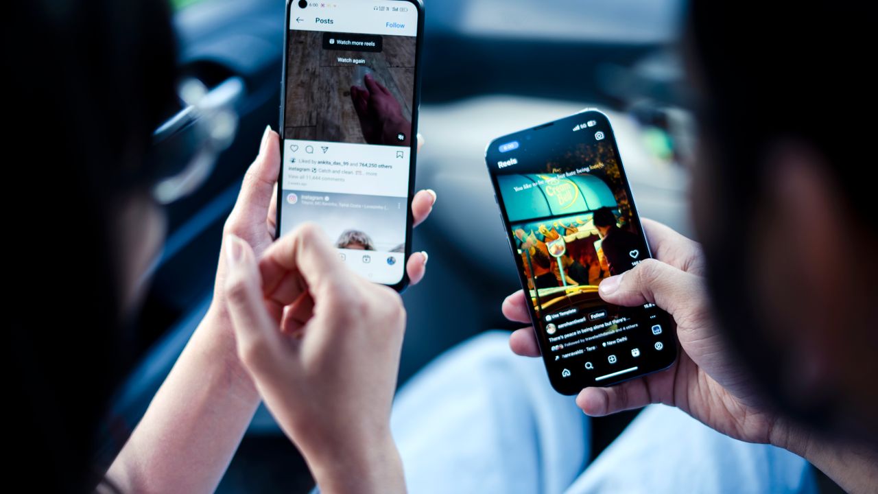Two people looking together at Instagram on a smartphone, the kind of everyday scroll session where Instagram ads compete for attention.