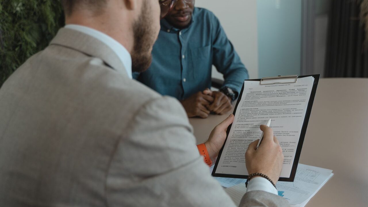 A recruiter reviewing a candidate's documents during an interview