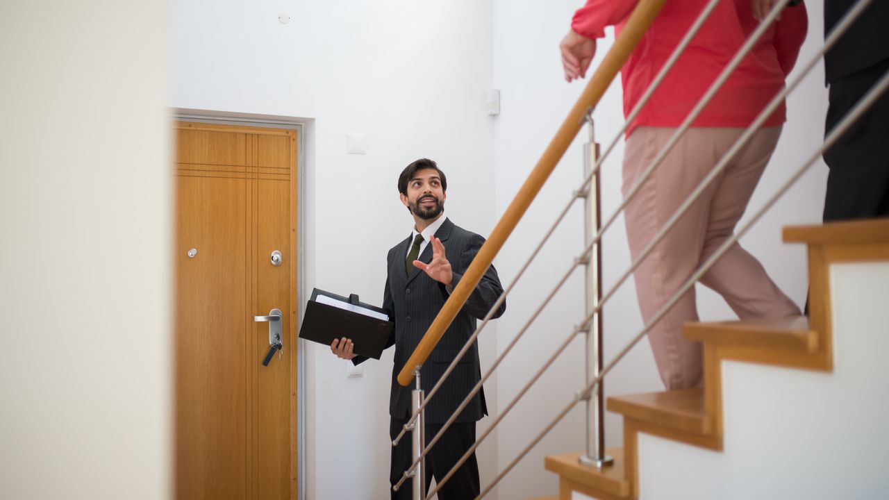 A real estate agent walking a couple through a home during a showing